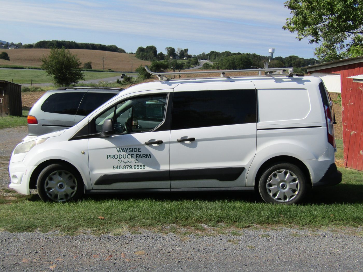 The Wayside Produce Farm delivery van parked by the barn